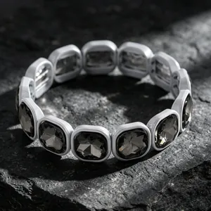 Close-up detail showing dark smoke grey square gemstone facets on stretch bracelet