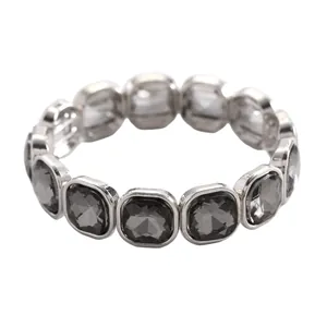 Detail of a geometric elastic bracelet with square grey crystals in silver frames