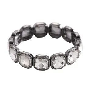 Detail macro view of elegant gunmetal stretch bracelet with square cut clear crystals.