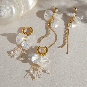 Detail view of two styles of elegant acrylic petal earrings with gold tassels