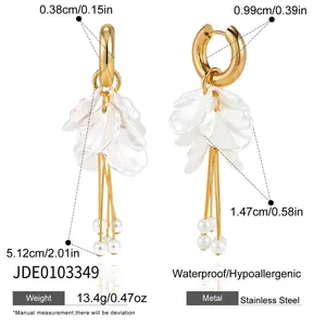 Close-up of waterproof stainless steel earrings featuring white acrylic petals and pearl tassels