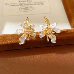 Exquisite gold flower hoop earrings with white oil-dripped petals and zircons.