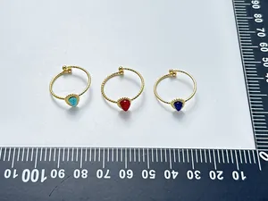 Detailed view of three 18K gold plated rings with water drop natural stones and sizing ruler