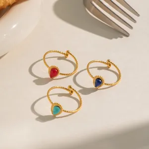 Detail of vintage 18K gold plated rings with water drop natural stones and twisted band