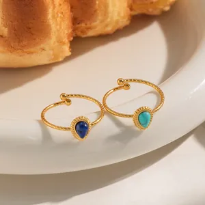 Close-up of 18K gold-plated twisted rings featuring teardrop natural stones in retro style