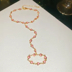 Detail of pink heart crystal finger bracelet in gold finish