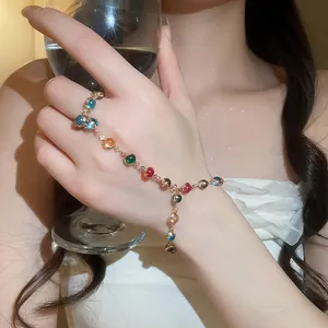 Close-up detail of colorful dopamine crystal finger bracelet hand chain on model