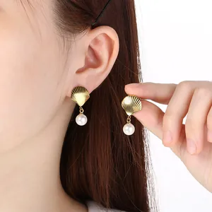 Elegant golden metal shell drop earrings with white pearl pendants for summer resort style