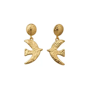 Elegant gold-tone swallow stud earrings featuring a unique hammered metal texture design