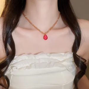 Elegant close-up of a French style crystal beaded necklace featuring a red teardrop pendant.
