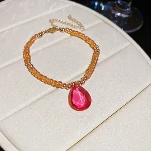Detailed view of French court style crystal beaded bracelet with a large pink teardrop pendant.