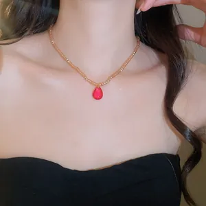 Close-up of French court crystal beaded necklace with elegant red teardrop pendant