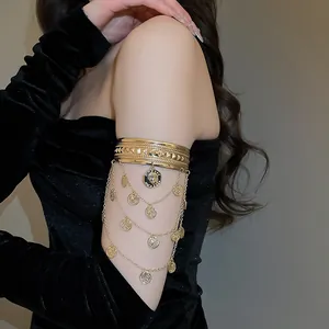 Bracelet de bras doré élégant avec chaînes multicouches et pendentifs en forme de pièce.