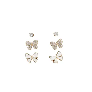 Set of three 14K gold plated butterfly and zircon stud earrings on a white background.