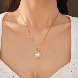 Detailed shot of a gold necklace with square pearl pendant and zircon accents