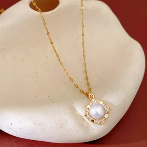 Close-up detail of a gold zircon square pendant necklace featuring a round pearl center