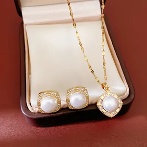 Close-up of gold-plated square pearl necklace and earrings set in an elegant box