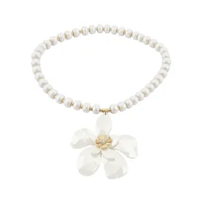French vintage beaded necklace with elegant rhinestone flower pendant on white background