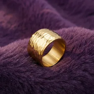 Detailed macro view of wide golden hammered texture stainless steel ring