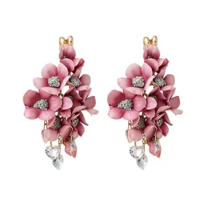 Elegant pink fabric flower tassel earrings with heart crystal pendants on white background