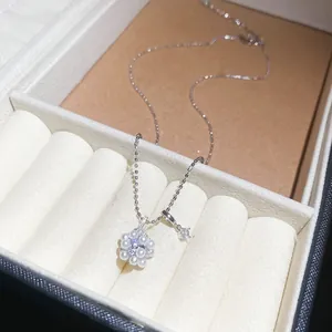 Élégant collier fleur en perles et zircons présenté dans un écrin à bijoux de luxe