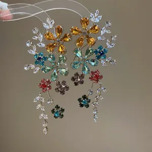 Vue détaillée de boucles d'oreilles fleurs en cristal avec strass brillants.
