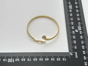 Detailed scale measurement of gold snake-shaped bangle with engraved scale texture