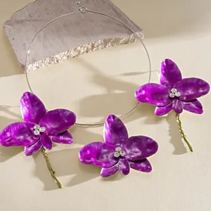 Exquisite detail of vintage purple orchid flower jewelry set with sparkling rhinestones