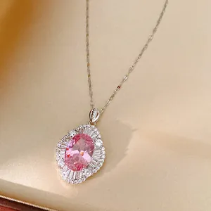 Close-up of elegant pink oval zircon pendant necklace with sparkling stone accents