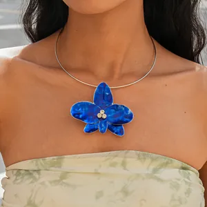 Close-up of a vintage-style blue enamel orchid choker necklace with crystal details
