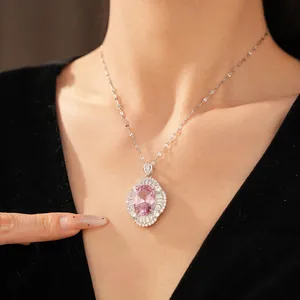 Detail view of an elegant oval pink zircon pendant necklace with diamond-like accents