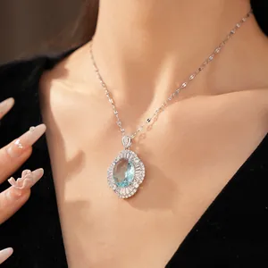 Exquisite close-up of a vintage oval blue zircon pendant necklace worn by a female model