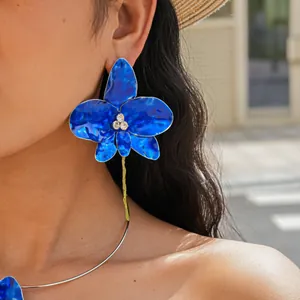 Detail of vibrant blue enamel flower earring and matching choker set with rhinestones.