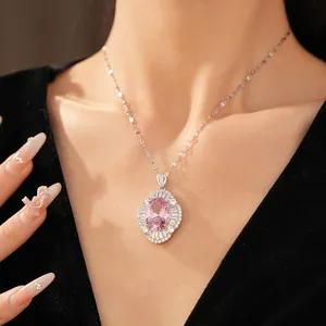 Detailed close-up of a vintage oval pink zirconia necklace pendant worn on a female model