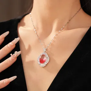 Elegant oval red gradient crystal necklace with sparkling zircon halo on a model
