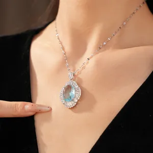 Elegant oval light blue gemstone necklace with sparkling zircon halo detail.