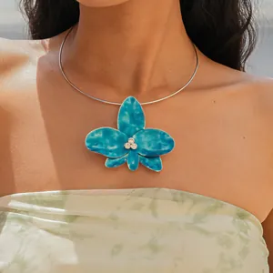Detailed view of an elegant blue enamel orchid flower choker necklace with rhinestones on model
