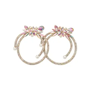 Elegant gold hoop earrings featuring multicolored rhinestones and delicate pearl accents