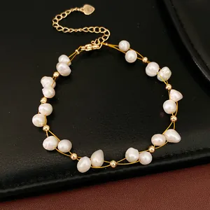Detail view of a dainty 18k gold-plated beaded bracelet with elegant freshwater pearls