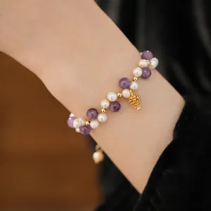 Close-up of 18k gold plated beaded bracelet with freshwater pearls and amethyst