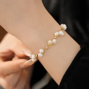 Close-up of an elegant 18k gold plated freshwater pearl bracelet on a woman's wrist