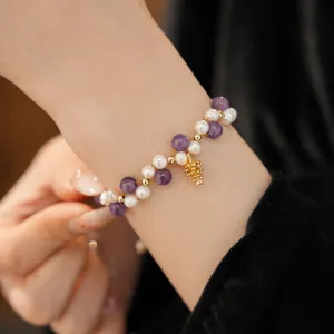 Detail view of 18k gold plated bracelet with freshwater pearls and amethyst beads