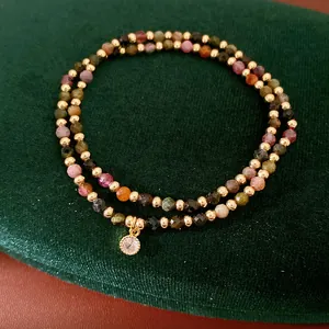 Close-up of 18k gold-plated double-layer bracelet with colorful beads and zircon charm