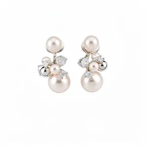 Elegant cluster clip-on earrings featuring white pearls and sparkling zircons in silver