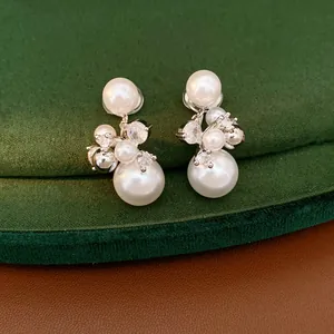 Detailed close-up showing elegant clustered pearl and cubic zirconia clip-on earrings