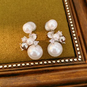 Elegant silver-toned pearl and cubic zirconia clip-on earrings in a vintage setting