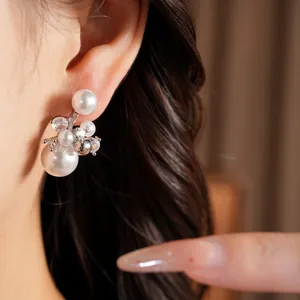 Detailed macro view showing the elegant cluster of white pearls and zircons on an ear clip