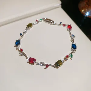Detailed close-up of Monet Garden style vine bracelet with colorful zircons and silver finish.