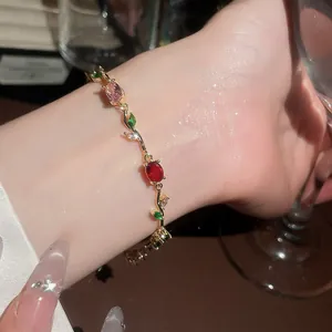 Close-up of elegant vine-themed bracelet with colorful zircon gemstones on wrist