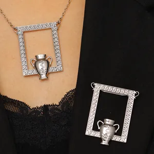 Detailed view of silver vintage bouquet brooch on a black blazer with classical bottle motif